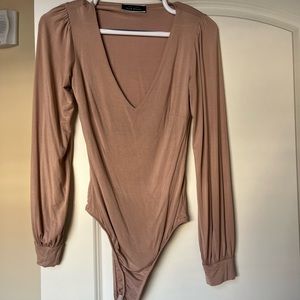 Neutral colored long sleeve body suit